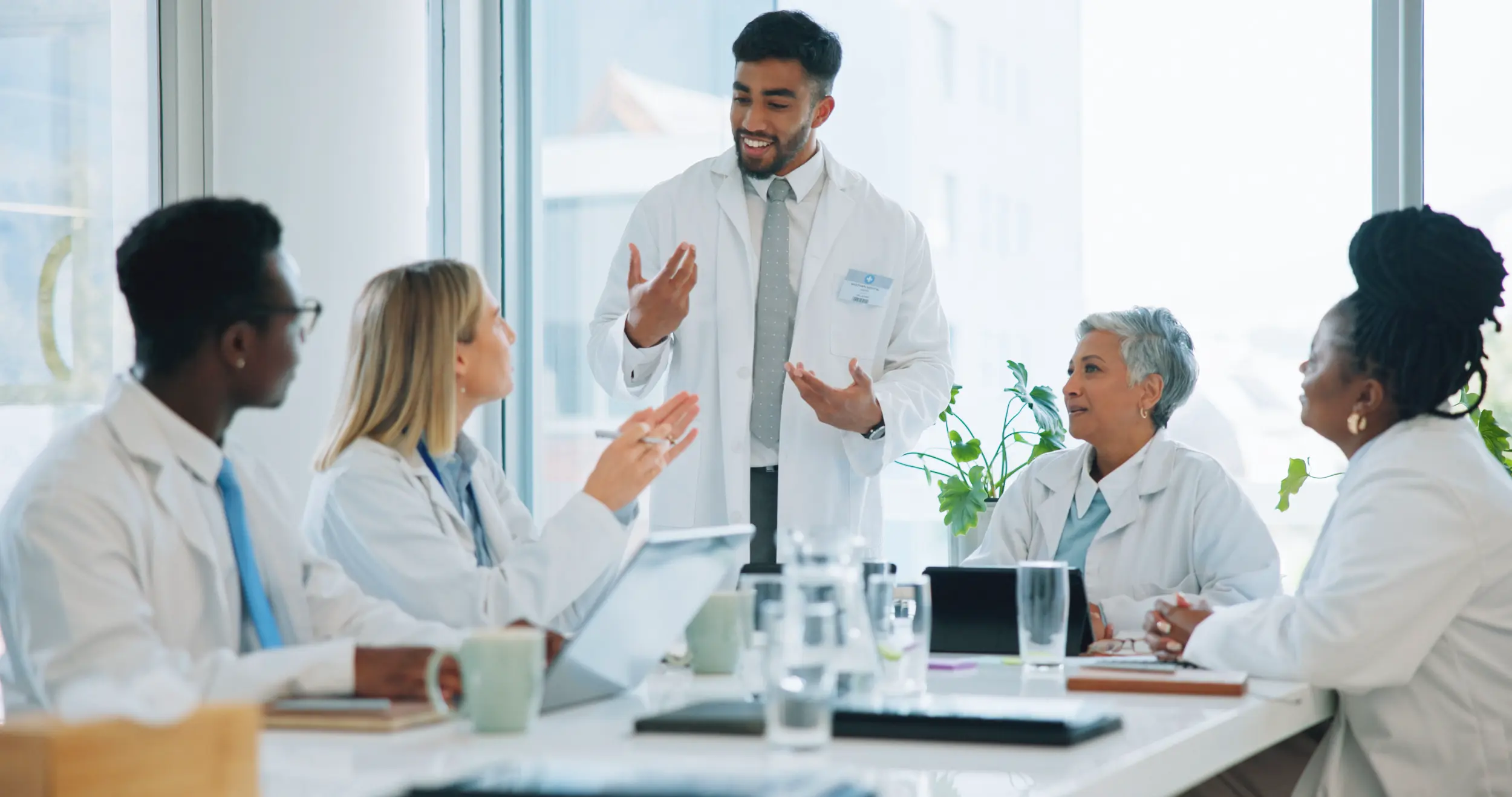 man doctor and team in meeting for healthcare pl 2026 03 25 02 48 42 utc