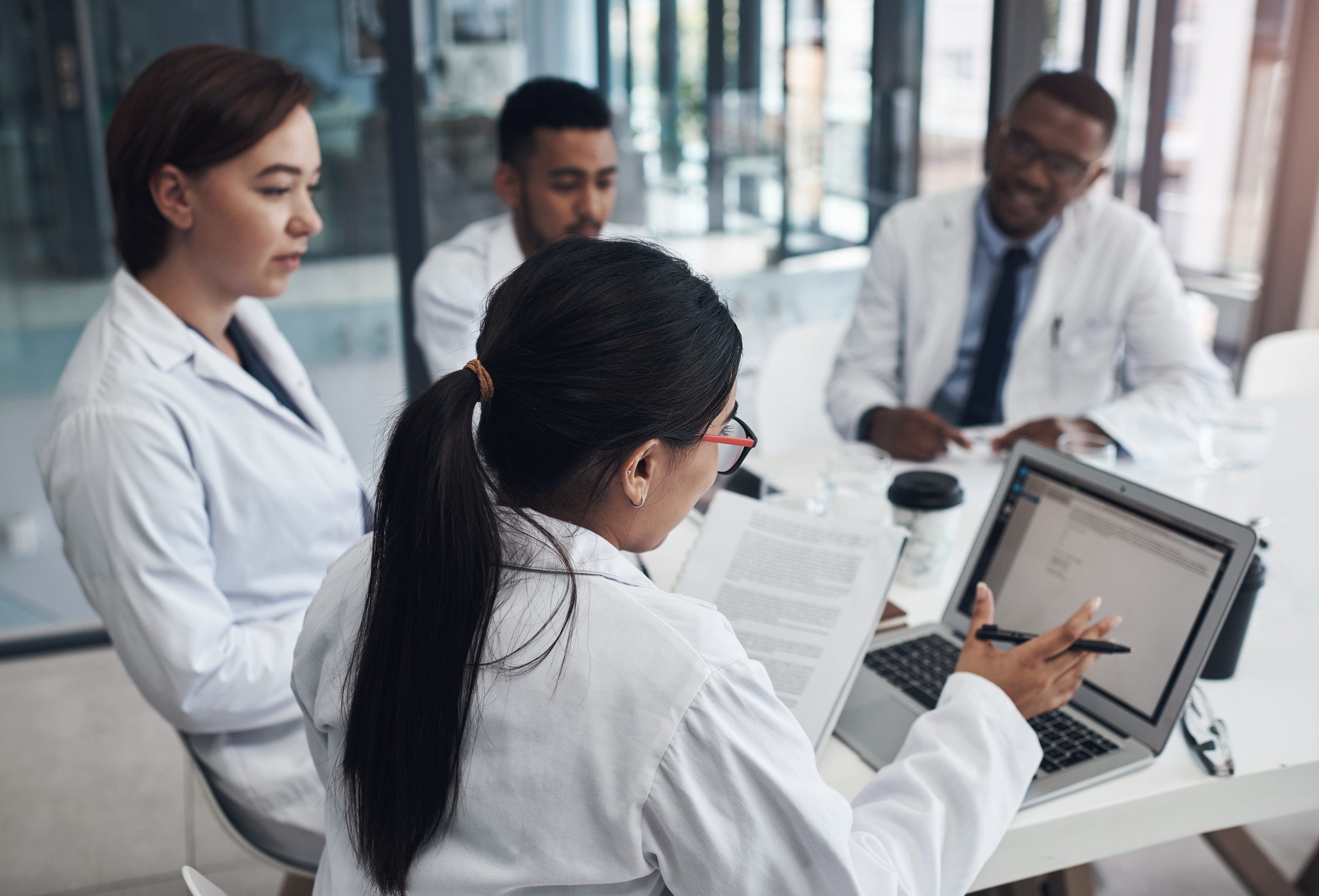 medical professionals collaborate during a meeting utc